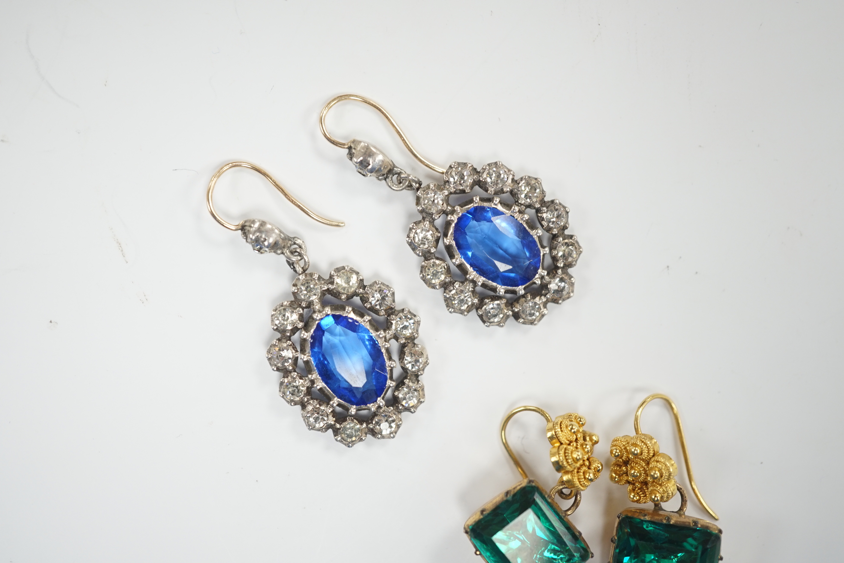 A pair of yellow metal and foil backed green paste set drop earrings, 11mm and a pair of blue and white paste set cluster drop earrings.